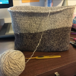 Working on a crochet bag made from unraveled thrift store sweaters.